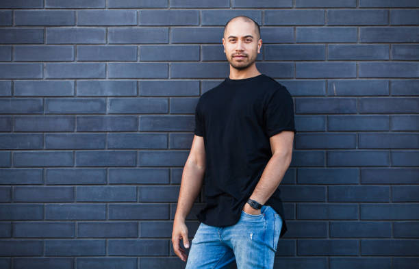 istock Confident young Maori man standing against brick wall. 899113998