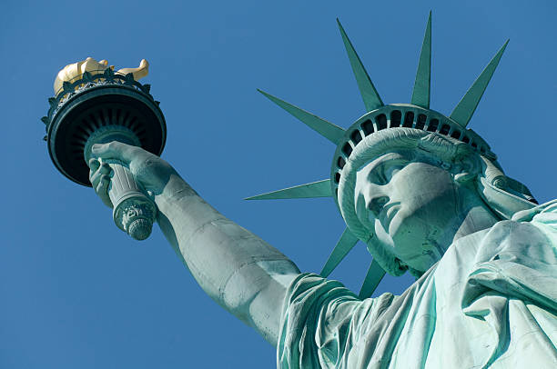 Close-up of the Statue of Liberty with a blue background The Statue of Liberty Enlightening the World was a gift of friendship from the people of France to the people of the United States and is a universal symbol of freedom and democracy. Please see my America lightbox: statue of liberty stock pictures, royalty-free photos & images