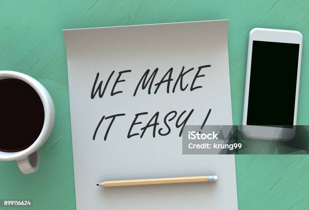 We Make It Easy Message On Paper Smart Phone And Coffee On Table Stock Photo - Download Image Now