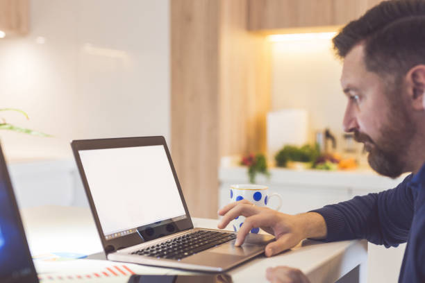 istock Young businessman working in home kitchen 899116994
