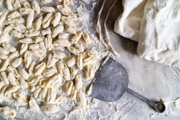 Cavatielli or Cavatelli. Italian traditional fresh homemade pasta on a marble table