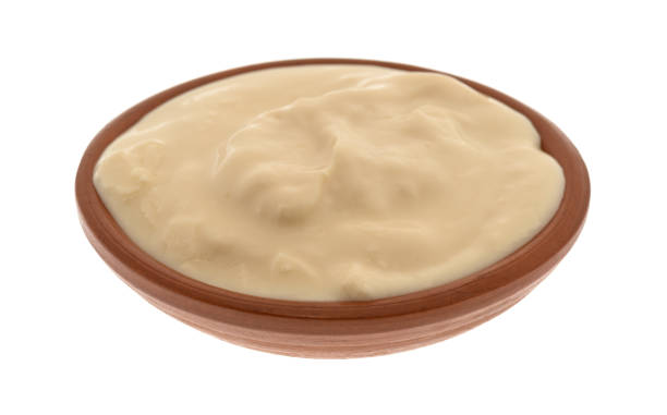 istock Bowl of caramel yogurt on a white background 899117650