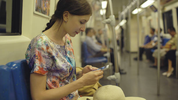 young woman tourist travelling in subway and looking in map at smartphone in bangkok subway during vacation - business blurred motion text messaging defocused imagens e fotografias de stock