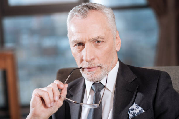 istock Handsome senior man scrutinizing you 899117964