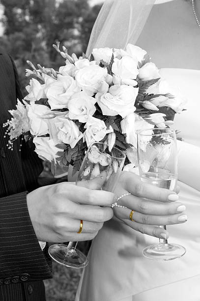 Cropped Image Of Newlywed Couple Touching Bouquet