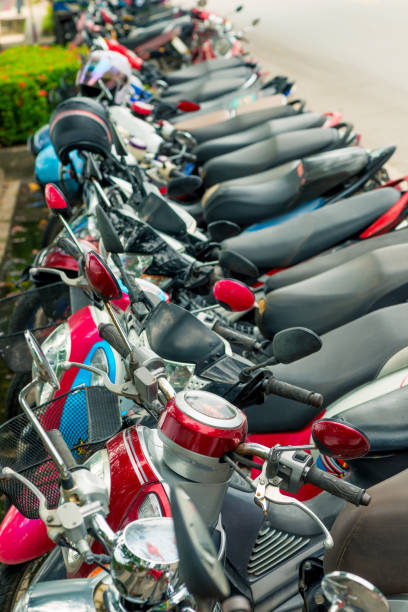 istock moped parked at the pavement in a row in Thailand 899121192