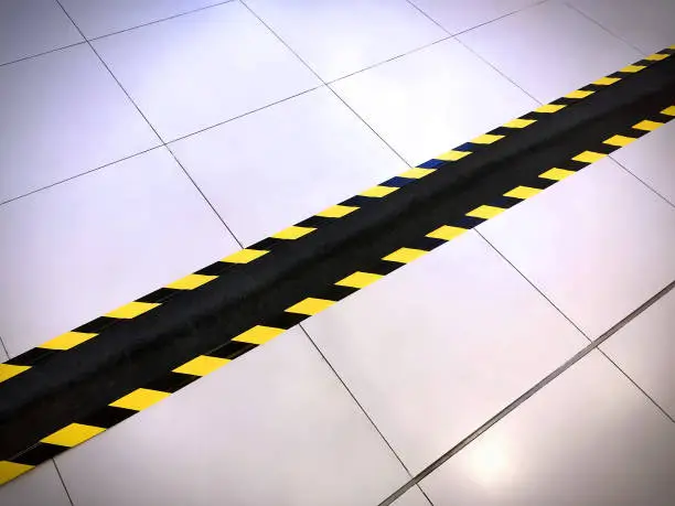 Yellow and Black Warning Stripes on Black Tape Covering Electrical Wire Duct