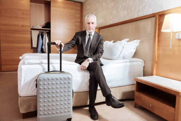 istock Senior glad man arriving at hotel 899121856