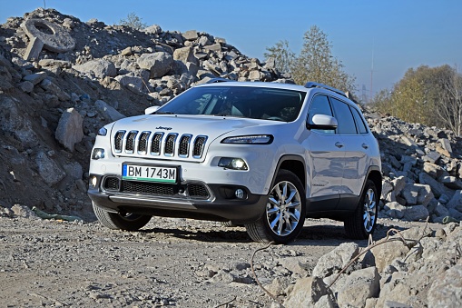 Warsaw, Poland - 28th October, 2014: Jeep Cherokee parked on the rocks. This model is one of the most popular SUV vehicles from Jeep.