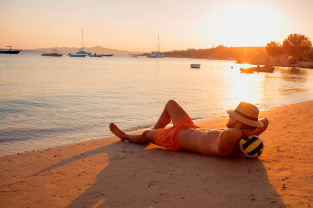istock man enjoying the sunset on the beach 899125626