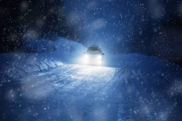 istock Car lights in winter forest 899130392