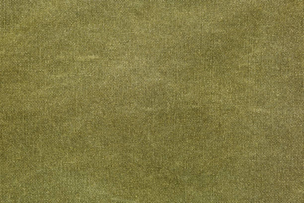 Rough olive canvas texture Horizontal piece of rough canvas fabric, olive colored. Vintage style unevenly painted dense textile with traces of usage. khaki green photos stock pictures, royalty-free photos & images