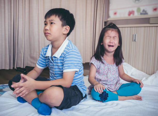 Quarreling conflict of children. Relationship difficulties in family concept. stock photo