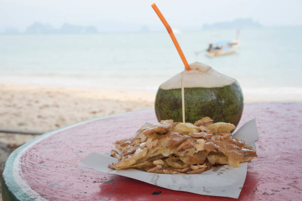 istock Coconut juice and crispy flat bread with cashew nuts (or Roti) on the table 899144814