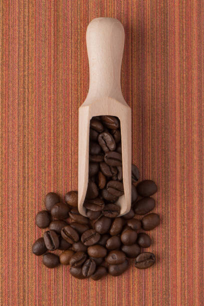 istock Wooden scoop with coffee beans 899145596