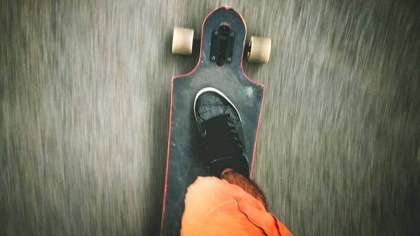 istock Longboarder driving on the street 899146112