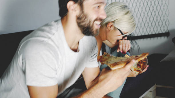 istock Couple eating pizza and have fun 899146198