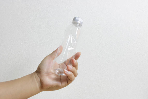 istock Hand holding a empty plastic bottle for recycle on white background. 899150052