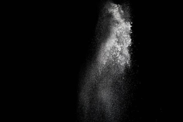 istock Freeze motion of white particles on black background. White granule explosion. Abstract white dust overlay texture. 899156358