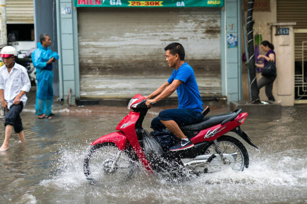Hoi An, Danang, Vietnam, 18 December 2016: Two motorbike are parked on flooded street in the historic old town of Hoi An, Vietnam