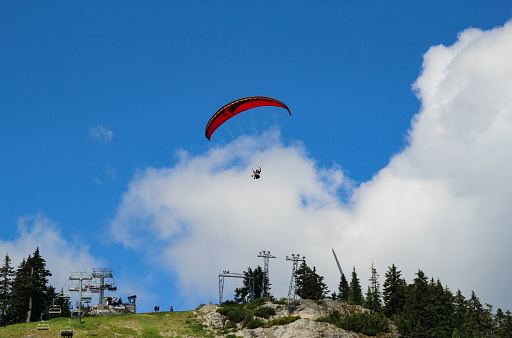 Paragliding launching from the Grouse Mountain in Vancouver, Canada