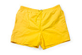 Yellow pair of swim trunks on white background
