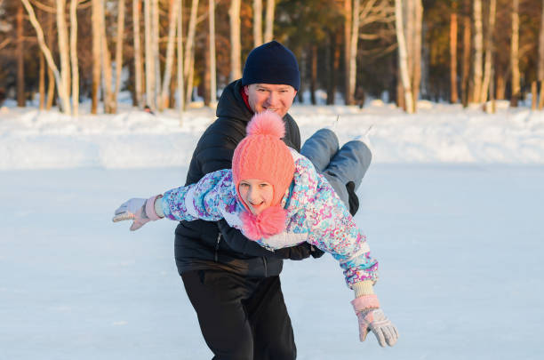 istock Father and daughter ice skating 899173730