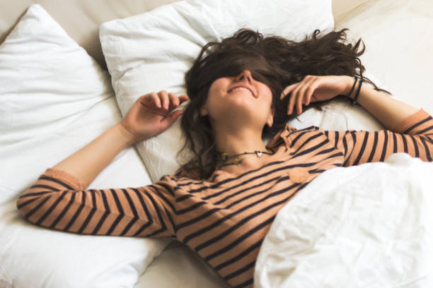 istock Smiling woman in her bed 899176856