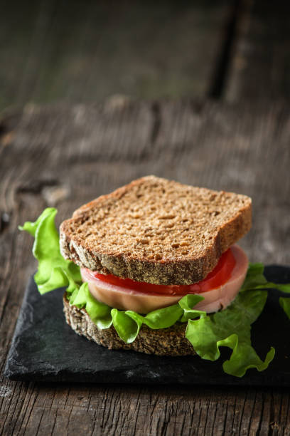 istock sandwich with sausage, bread, tomato and lettuce 899176984