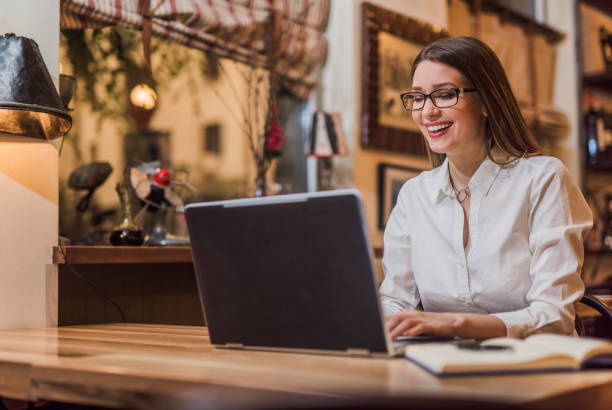 istock Cheerful young woman using laptop at home. 899183036