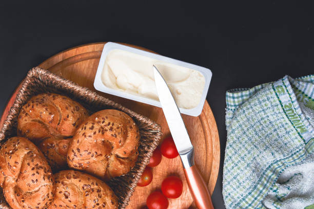 istock Breakfast served. Cooked buns with cherry tomatoes and melted cheese on the table. 899183258