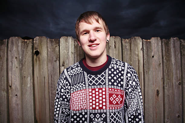 istock Ugly Sweater Guy by a Fence at Night 89918750