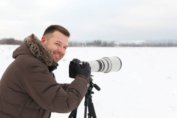 istock Man taking pictures in winter 899195324