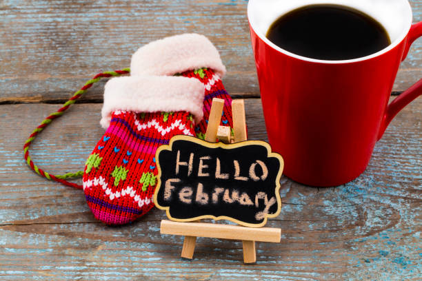 istock Concept HELLO FEBRUARY message on blackboard with a Cup of coffee and mittens 899199816