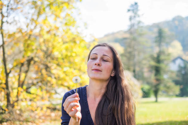 istock Young beauty women holding dandelion 899200802