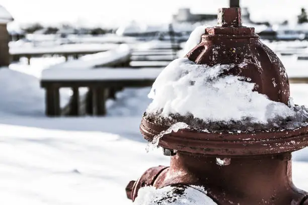 Photo of Fire hydrant, surrounded by snow and ice