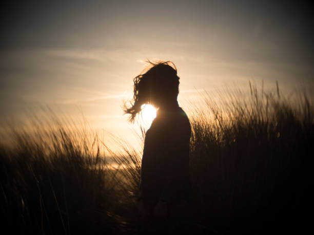 istock Child smiling amongst the sand dunes 899203614