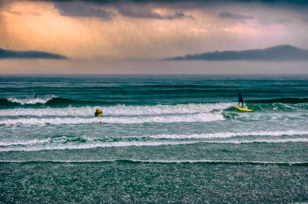 istock Surfing the waves under a rainstorm. 899206394