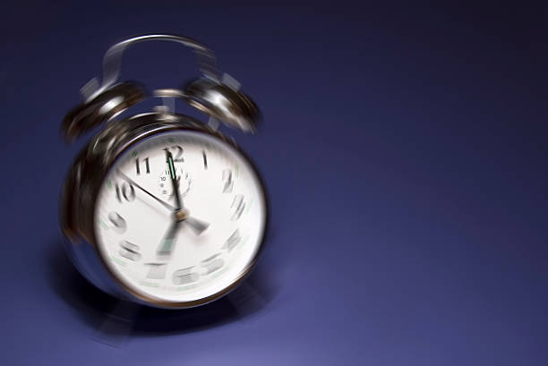 Ringing alarm clock on blue background stock photo