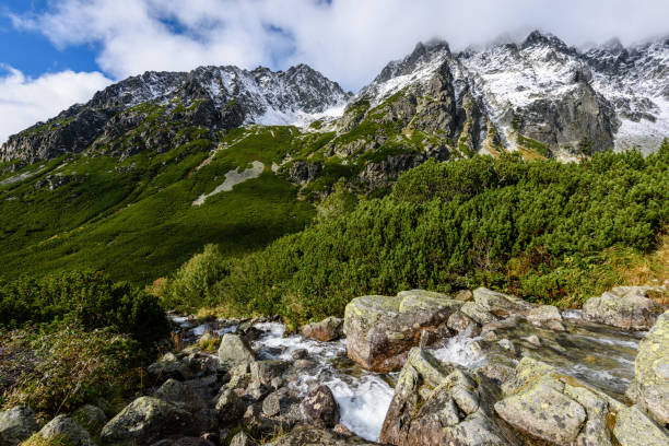 istock large Waterfall from ravine in autumn, long exposure with mountains in background 899215410