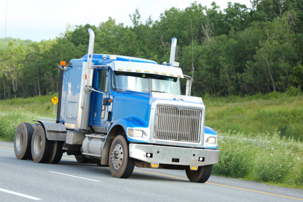 istock Semi-truck on a highway, tall grass 899218750