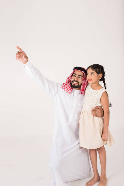 istock Arab father with his daughter showing her something 899219268