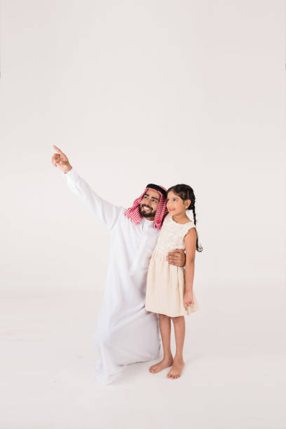 istock Arab father with his daughter showing her something 899219280