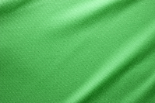 Cotton Fabric Full Frame Texture. Top View of Cloth Textile Surface. Green Clothing Background. Text Space