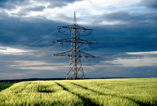 High voltage power lines in rural landscape