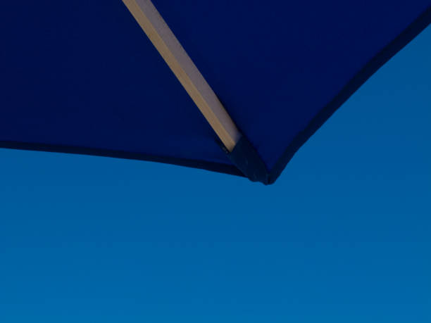 Beach umbrella corner against blue sky stock photo