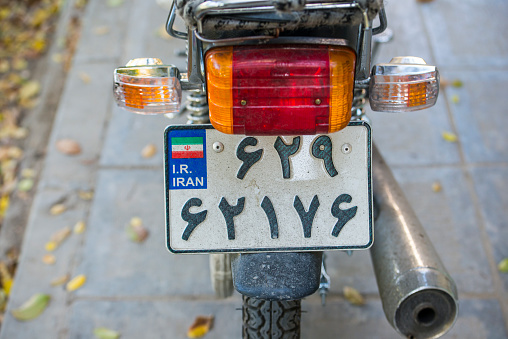 Isfahan, Iran - November 11, 2015: Iranian number plate on a small motorcycle.