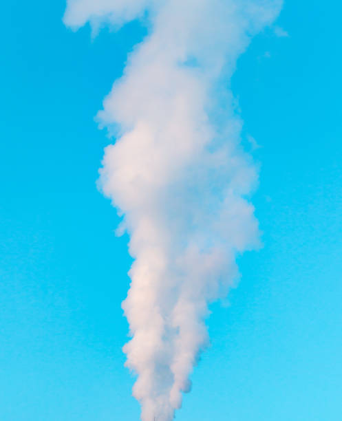 istock white industrial smoke from the chimney on a blue sky 899230004