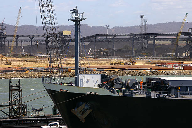 Coal terminal 3 Bulk carrier moored at coal loading port of Gladstone, Queensland, stockpiles and conveyor belts in background. gladstone michigan stock pictures, royalty-free photos & images