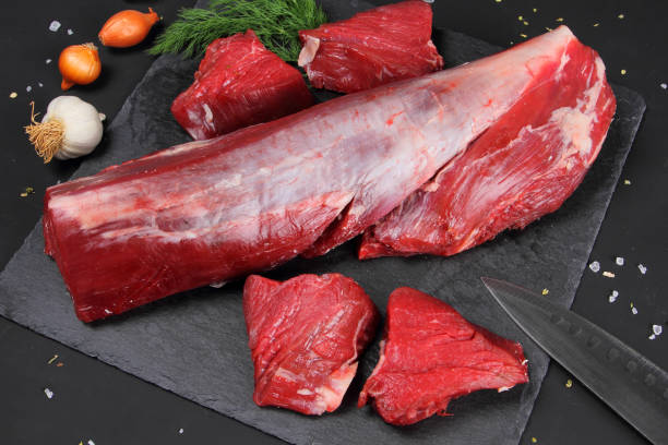 istock Raw Meat on the Black Background 899233650